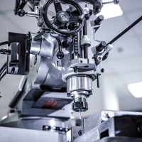 Metalworking CNC milling machine. Metalworking CNC milling machine. Cutting metal modern processing technology. Small depth of field. Warning - authentic shooting in challenging conditions. A little bit grain and maybe blurred.
